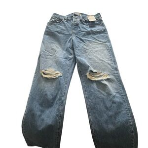 Madewell Distressed Blue Jeans with shopping bag